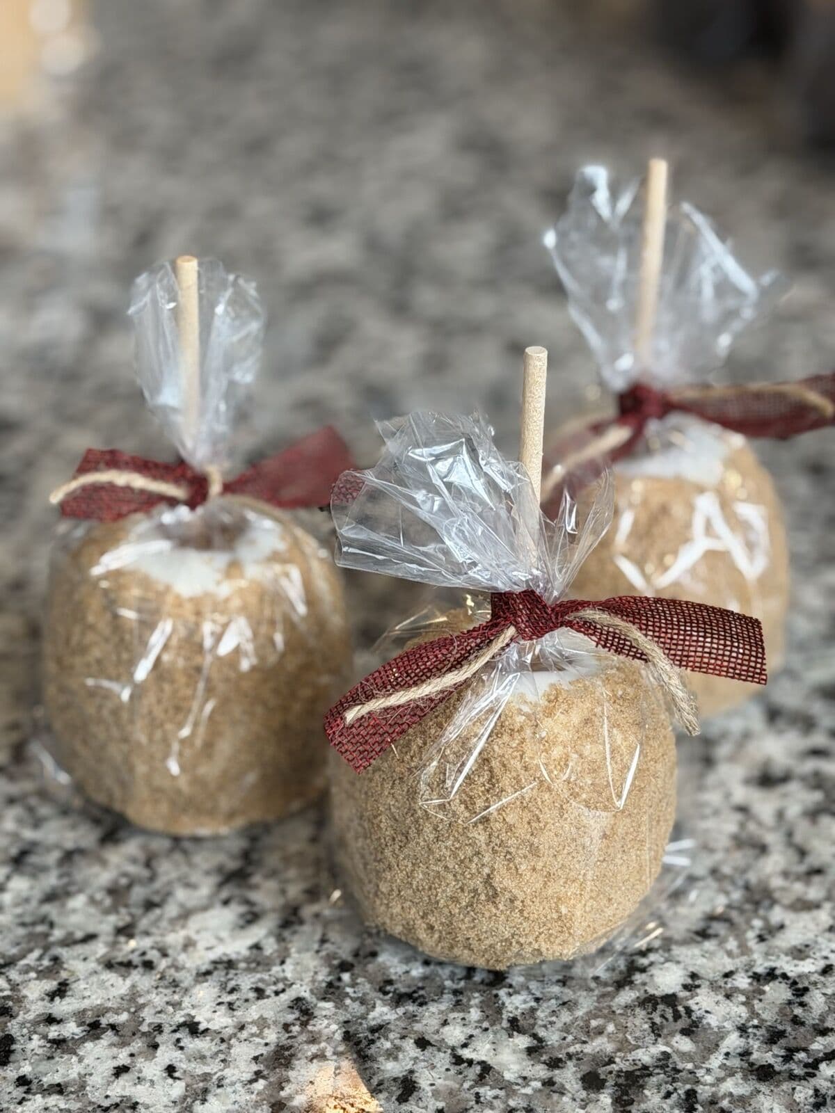 Wrapped caramel apples tied with ribbon